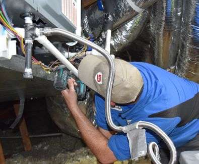 Technician repairing a home's HVAC unit.