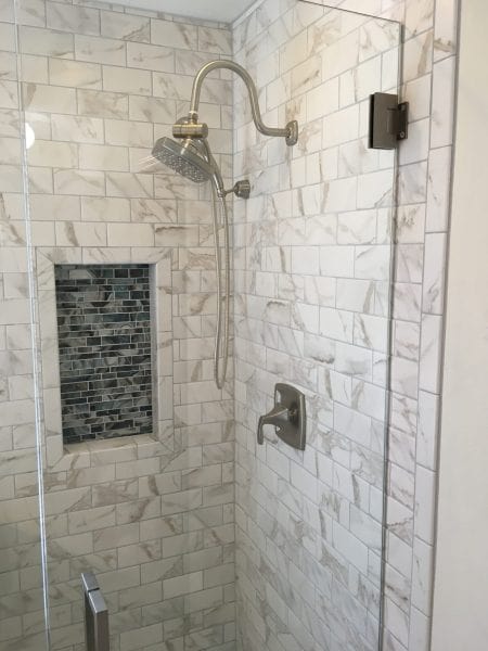 Marble colored glass-enclosed shower following shower repair and shower installation in Denton, TX