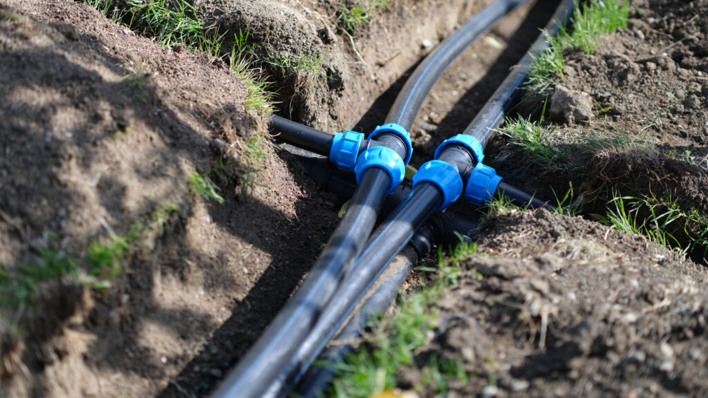 Installed PVC water pipes in trench.